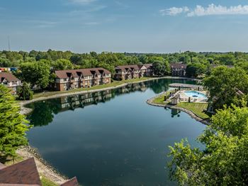 Community lake with ample green space at bavarian village apartments, indiana